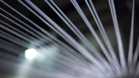 Wide perspective view of stretched textile threads forming converging lines loom Stock Footage 321887224