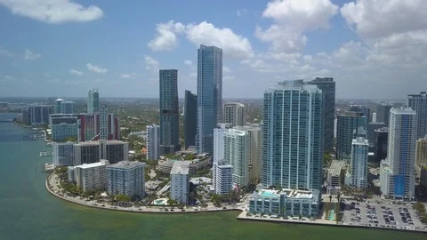 Wide puffy clouds flying clockwise around tip of downtown Miami skyline Stock Footage 88488894