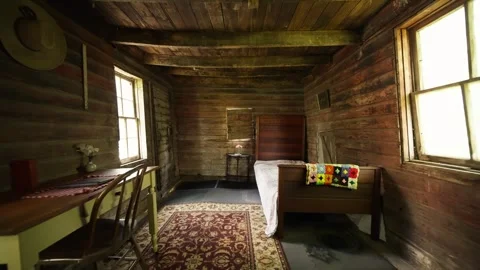 Wide push in shot of an old style bedroom with all wood finishes including Stock Footage 250338185