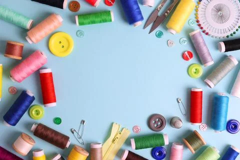 A wide range of sewing materials and tools is located on a colored background Stock Photos