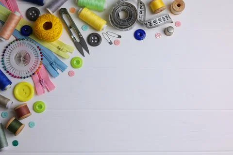 A wide range of sewing materials and tools is located on a colored background Stock Photos