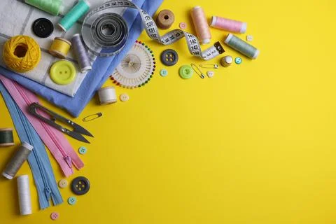 A wide range of sewing materials and tools is located on a colored background Stock Photos