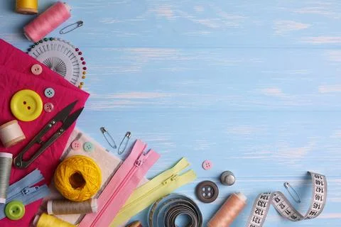 A wide range of sewing materials and tools is located on a colored background Stock Photos