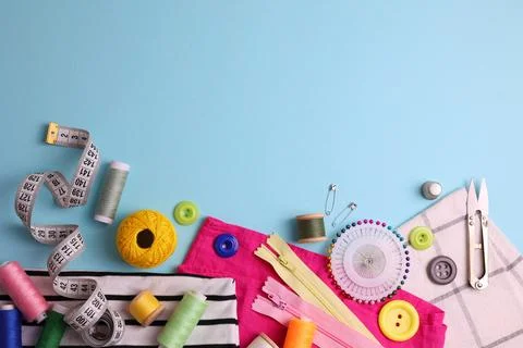 A wide range of sewing materials and tools is located on a colored background Stock Photos
