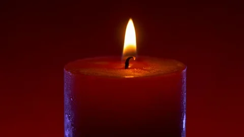 Wide red candle flame on red background with blue rim light Stock Footage 122867062
