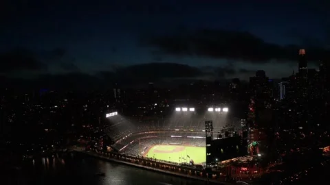Wide reverse aerial pullback shot of Oracle park at night with the San Stock Footage 172480811