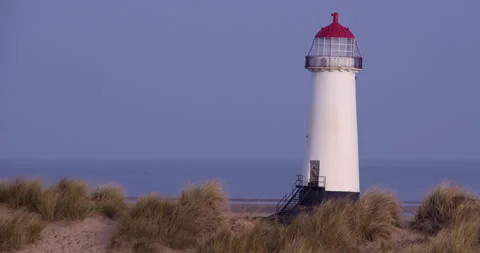 Wide right of Frame shot of point of ayr lighthouse with marram grass and sand Stock Footage 346191485