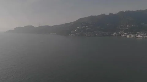 Wide right to left tracking of river toward hill Stockbeeldmateriaal 336792404