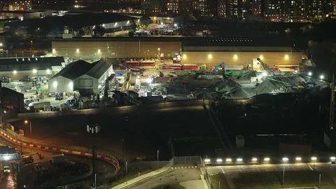 Wide rising aerial of construction site by O2 Arena in London at night Stock Footage 302914947