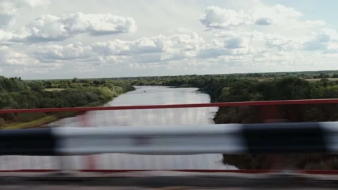 Wide river and blue sky. View from the car driving over the bridge Stock Footage 204095135