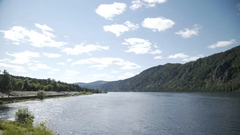 Wide river and mountains in background. Divnogorsk city near Yenisei river. Video stock 174788430