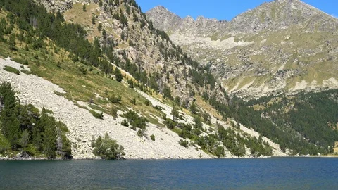 Wide river with clear water flows next to a high mountain. national park Stock Footage 114834746