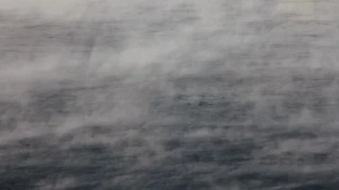 Wide river does not freeze in winter, steam rises into air from cooling river Video stock 128979563