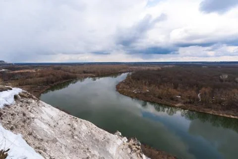 Wide river in spring. snow on the river Bank. overcast sky Stock Photos