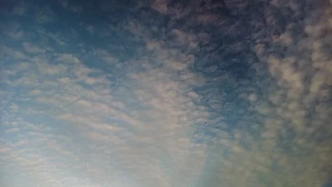 A wide river of tiny white clouds on a blue background  Stock Footage 273740331