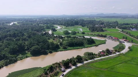 Wide river winds through lush green fields Stock Footage 344813705