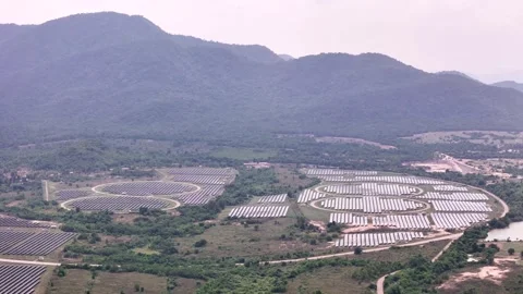 Wide round solar power fields with mountain background in tropical country Stock Footage 309182335