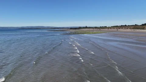 Wide Sandy Beach and Shallow Water in 4K Stockbeeldmateriaal 332943713