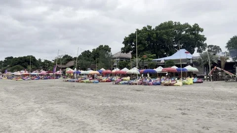 Wide Sandy Beach Toward Rows of Colorful Beach Umbrellas, Seminyak, Indonesia 4K Stock-Footage 238837759