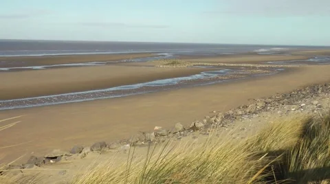 Wide sandy beach waving grasses in foreground wintry sky Stock Footage 47176882