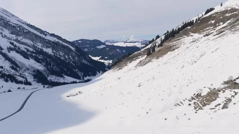 A wide, scenic view of the Col des Aravis mountain pass in the French Alps Stock Footage 346675646