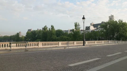 Wide scenic view of an empty stone bridge in Paris with a cobblestone roadway, a Stock Footage 338007358