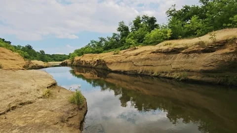 Wide scenic view of river bend flowing through sandstone canyon Stock Footage 343794091