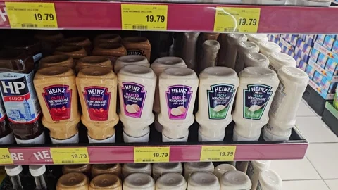A wide selection of squeezable Heinz condiment and sauce bottles displayed Video stock 341459780