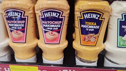 A wide selection of squeezable Heinz condiment and sauce bottles displayed Video stock 341459797