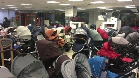 Wide selection of strollers for the mother to-be are in kids store. Russia 動画素材 107305617
