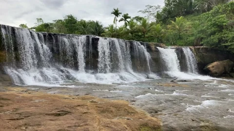 Wide short waterfall in West Java South Coast - "Dengdeng Waterfall" Stock Footage 236362647