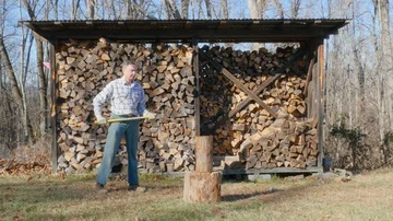 Wide Shot of an Active Senior Man Chopping Firewood in 4K Stock Footage 85872884