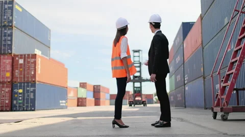 Wide shot of Asian cargo container worker man and woman work and discussion Stock Footage 146444937