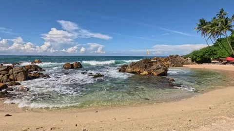 Wide shot of beautiful beach with powerful waves and breakwaters in Sri Lanka Stock Footage 339898513