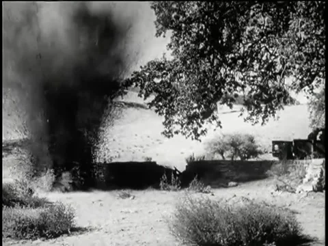 Wide shot bomb exploding near soldiers crouching behind low wall Stock Footage 260247941