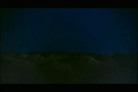 Wide shot bombs exploding in night sky Stock Footage 11346933