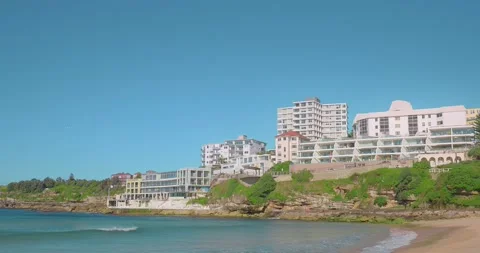 Wide shot of Bondi Beach with plane flying in background Stock Footage 196668963