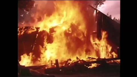 Wide shot of burning barn collapsing in flames, 1950s Stock Footage 260259155
