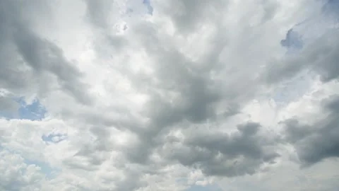 A wide shot captures a dramatic sky heavily covered with thick grey Stock Footage 339912592