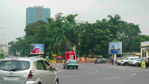 Wide shot of off-center roundabout with trees, Brazzaville Stock Footage 338167630