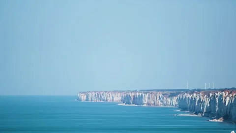 Wide shot of cliffs with wind turbines facing the sea in normady blu sky Stock Footage 140187341