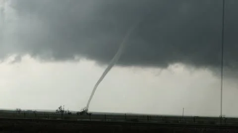 Wide shot of a close by slender tornado as it moves across the ground. Stock Footage 11436053