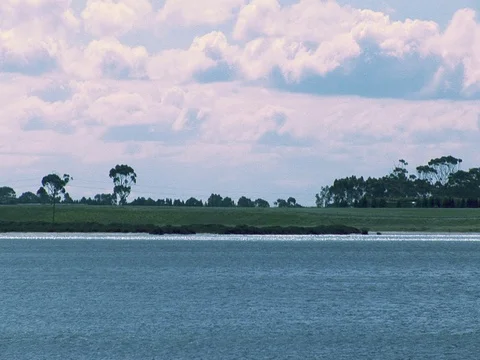Wide shot of clouds and lake or ocean water. Stock Footage 79939805