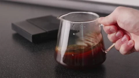 Wide shot of coffee aeration in server with scales in background Stock Footage 332720247