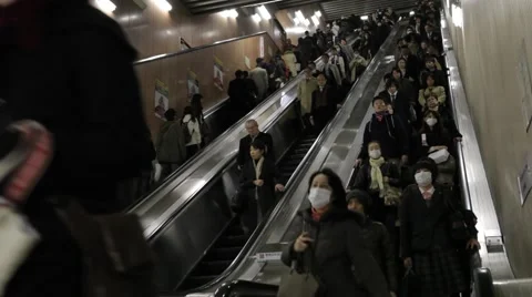 WIDE SHOT OF COMMUTERS ON ESCALATOR AT TRAIN STATION RUSH HOURS IN TOKYO Video stock 59921327