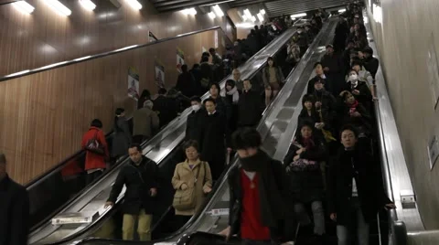 WIDE SHOT OF COMMUTERS ON ESCALATOR AT TRAIN STATION RUSH HOURS IN TOKYO Stock-Footage 59921361