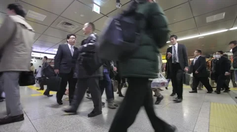 WIDE SHOT OF COMMUTERS WALKING AT RUSH HOUR TRAIN STATION TOKYO JAPAN Stock Footage 59922025
