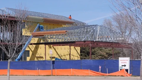 Wide Shot Construction Building Man On Roof Pan Left Stock Footage 86873249