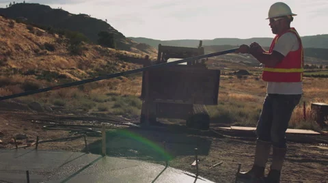 Wide shot of construction worker troweling concrete Stock Footage 55148352