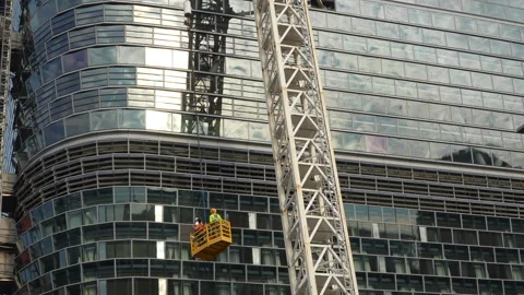 Wide shot of construction workers in elevated lift 스톡 동영상 332906850